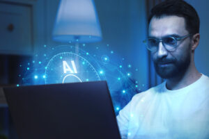 Homem utilizando seu notebook impactado por um gráfico representado o poder da inteligência artificial nos negócios